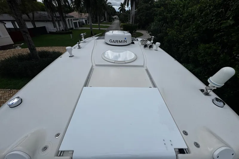  Yacht Photos Pics 2007 Hydra-Sports Vector 3300 VX boat deck with Garmin equipment, surrounded by lush greenery.