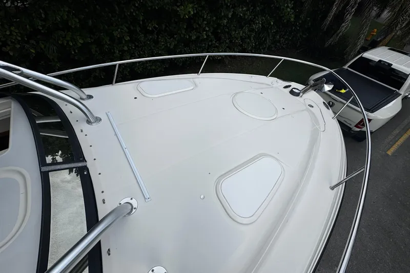  Yacht Photos Pics 2007 Hydra-Sports Vector 3300 VX boat deck with railing, parked beside a white vehicle.