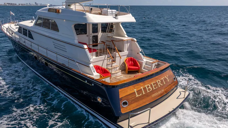 Liberty Yacht Photos Pics 2004 Lyman-Morse Motoryacht cruising on open sea with elegant design and spacious deck.