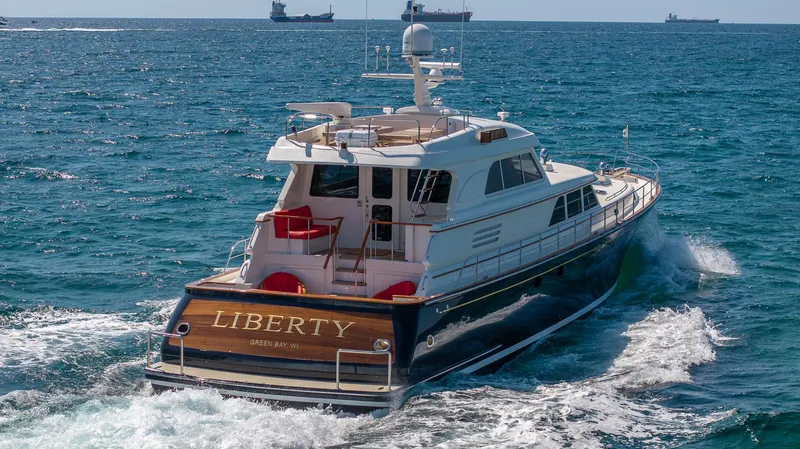 Liberty Yacht Photos Pics 2004 Lyman-Morse Motoryacht cruising on open sea with clear blue water.