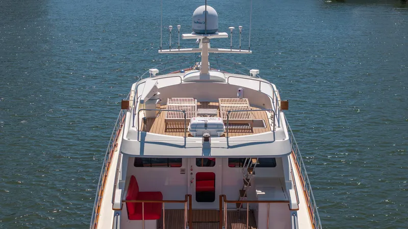 Liberty Yacht Photos Pics Lyman-Morse 2004 motoryacht on water, showcasing deck and seating area.