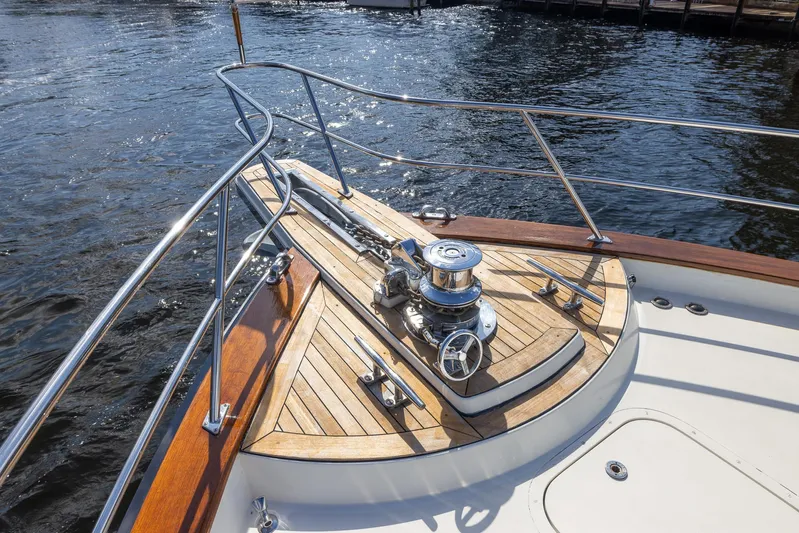 Liberty Yacht Photos Pics 2004 Lyman-Morse Motoryacht bow with teak deck and stainless steel fittings on water.