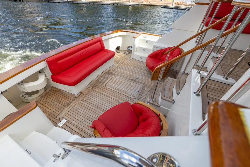 Liberty Yacht Photos Pics Luxurious 2004 Lyman-Morse Motoryacht deck with red seating and wooden flooring.