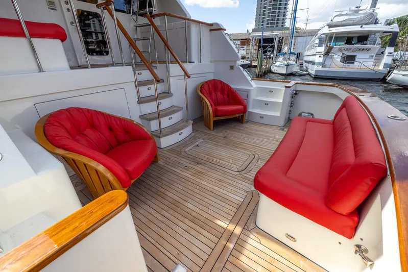 Liberty Yacht Photos Pics Luxurious 2004 Lyman-Morse Motoryacht deck with red seating and wooden flooring.