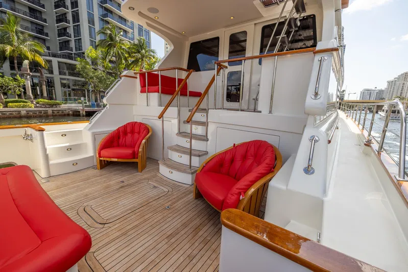 Liberty Yacht Photos Pics Luxurious 2004 Lyman-Morse Motoryacht deck with red seating and wooden accents.