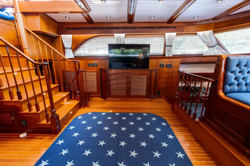 Liberty Yacht Photos Pics Luxurious 2004 Lyman-Morse motoryacht interior with wood paneling and star-patterned carpet.