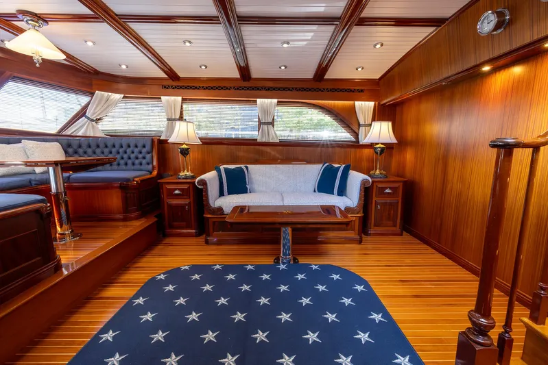 Liberty Yacht Photos Pics Luxurious 2004 Lyman-Morse Motoryacht interior with elegant wood paneling and plush seating.