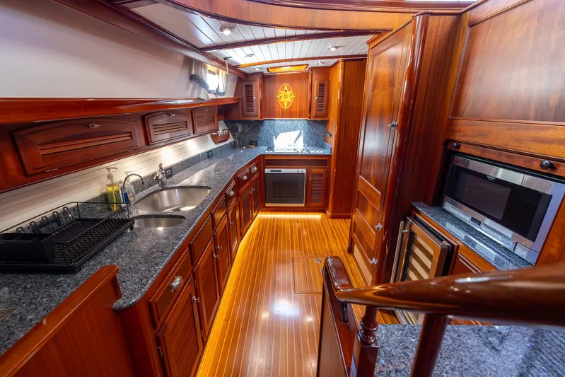 Liberty Yacht Photos Pics Luxurious 2004 Lyman-Morse Motoryacht kitchen with wood cabinetry and granite countertops.
