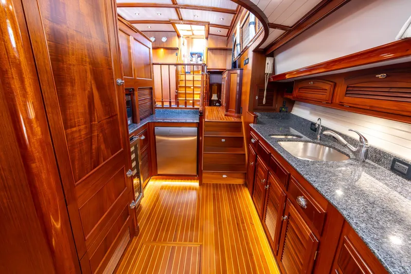 Liberty Yacht Photos Pics Luxurious 2004 Lyman-Morse Motoryacht interior with elegant wood finishes and modern kitchen amenities.