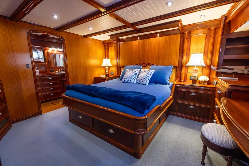 Liberty Yacht Photos Pics Luxurious 2004 Lyman-Morse motoryacht bedroom with elegant wood paneling and cozy lighting.