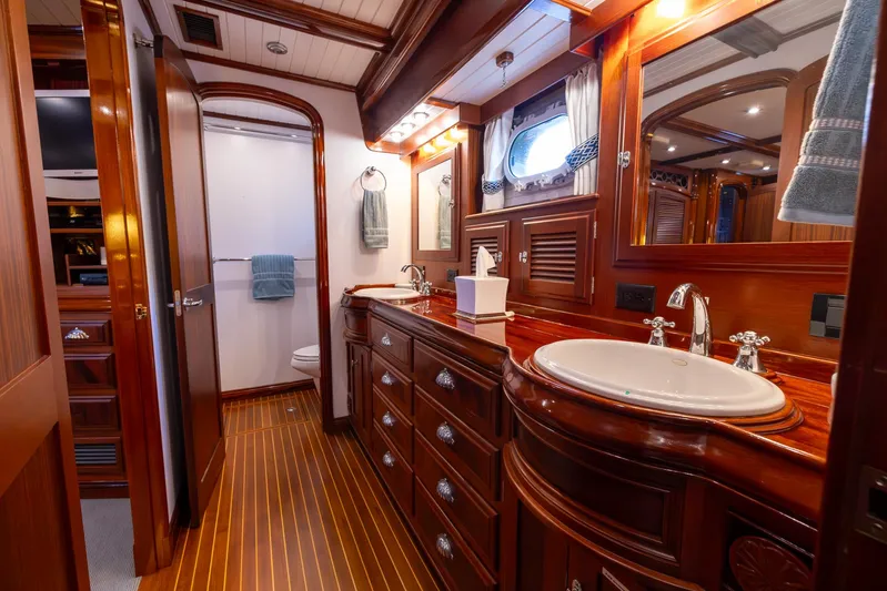 Liberty Yacht Photos Pics Luxurious 2004 Lyman-Morse Motoryacht bathroom with elegant wood finishes and modern fixtures.