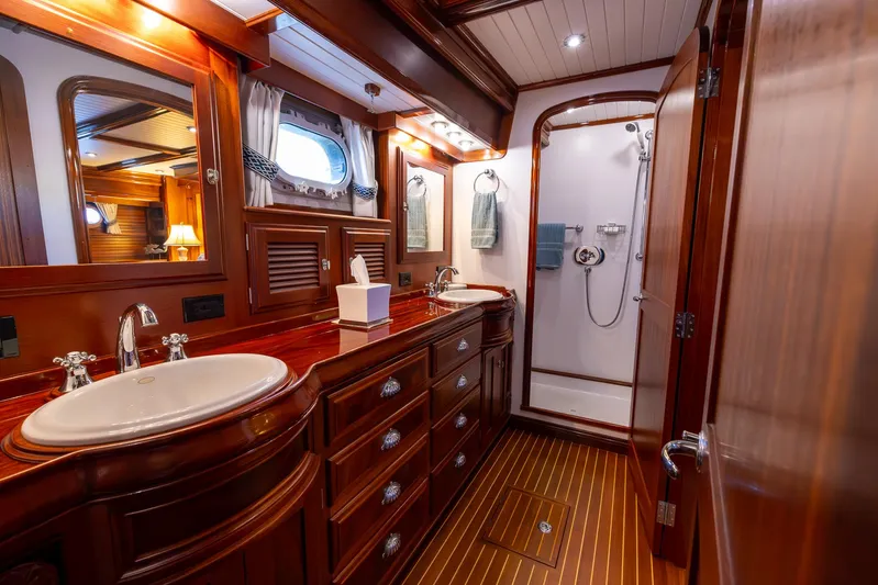 Liberty Yacht Photos Pics Luxurious 2004 Lyman-Morse motoryacht bathroom with wooden cabinetry and dual sinks.
