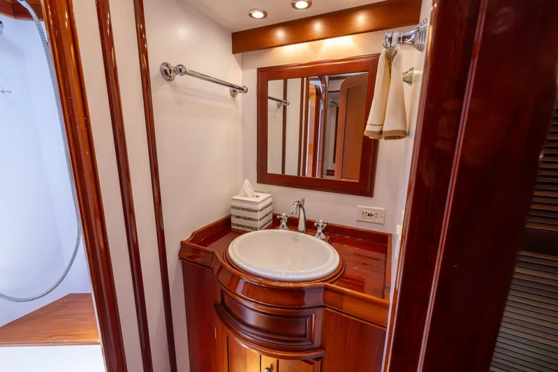 Liberty Yacht Photos Pics Luxurious bathroom in 2004 Lyman-Morse Motoryacht with elegant wood finish and modern fixtures.