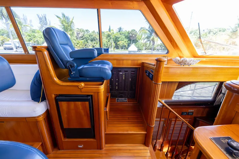 Liberty Yacht Photos Pics Luxurious 2004 Lyman-Morse Motoryacht interior with blue captain's chair and wooden finishes.