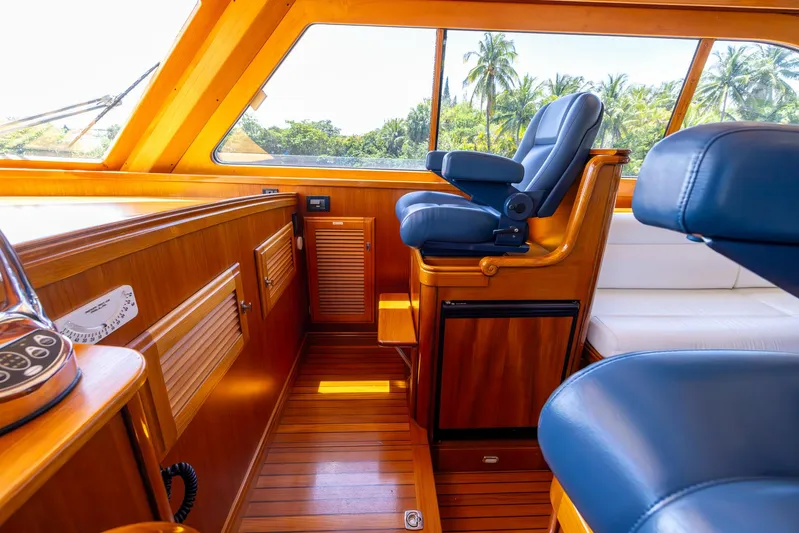 Liberty Yacht Photos Pics Luxurious 2004 Lyman-Morse Motoryacht interior with wooden finish and plush seating.
