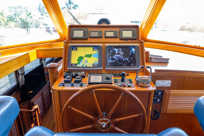 Liberty Yacht Photos Pics 2004 Lyman-Morse Motoryacht helm with navigation screens and wooden steering wheel.