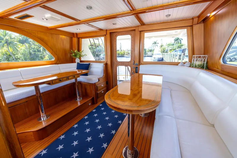 Liberty Yacht Photos Pics Luxurious 2004 Lyman-Morse motoryacht interior with elegant wood finish and white seating.