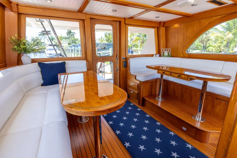 Liberty Yacht Photos Pics Luxurious 2004 Lyman-Morse motoryacht interior with elegant wood finish and white seating.
