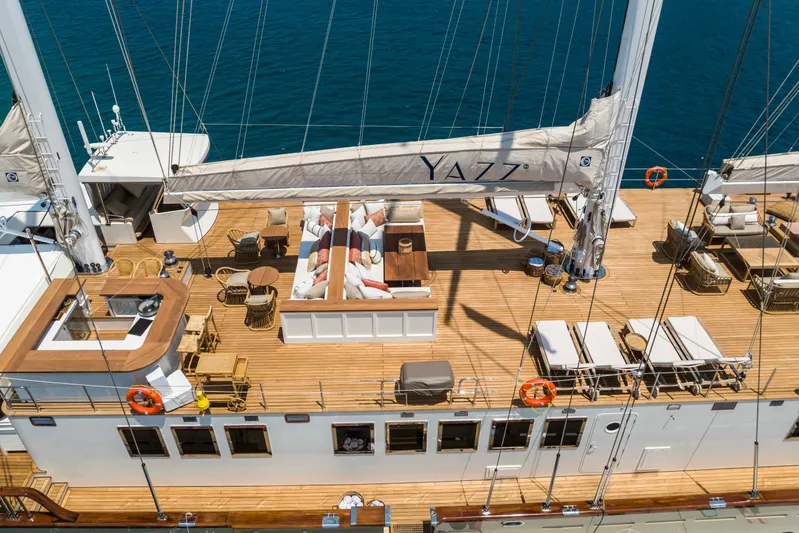 Yazz Yacht Photos Pics Luxurious 2007 Aegean Yacht deck with seating, tables, and sun loungers on open sea.