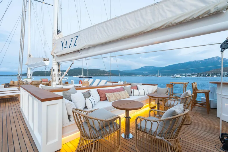 Yazz Yacht Photos Pics Luxurious 2007 Aegean Yacht deck with elegant seating, overlooking serene coastal waters.