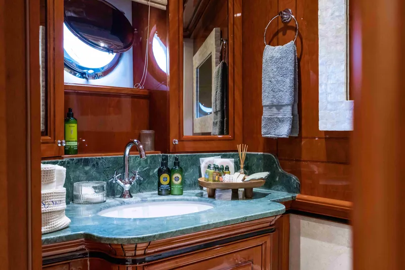 Yazz Yacht Photos Pics Luxurious bathroom on 2007 Aegean Yacht with green marble countertop and elegant wood finish.