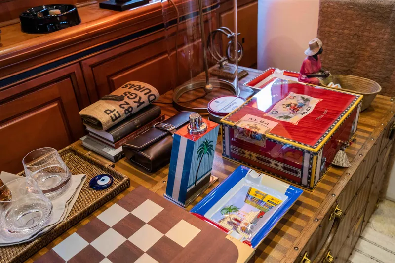 Yazz Yacht Photos Pics Luxurious yacht interior with decorative items, books, and a chessboard on a wooden surface.