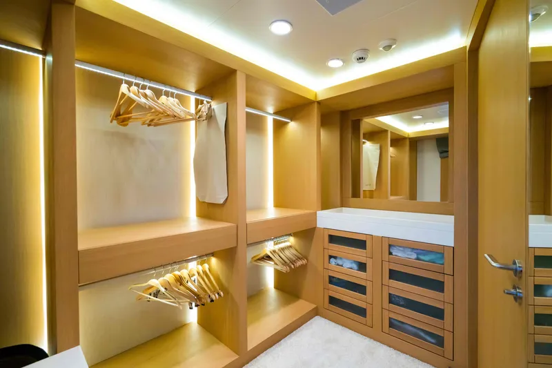 Yazz Yacht Photos Pics Luxurious wooden walk-in closet on 2007 Aegean Yacht, featuring ample storage and modern lighting.