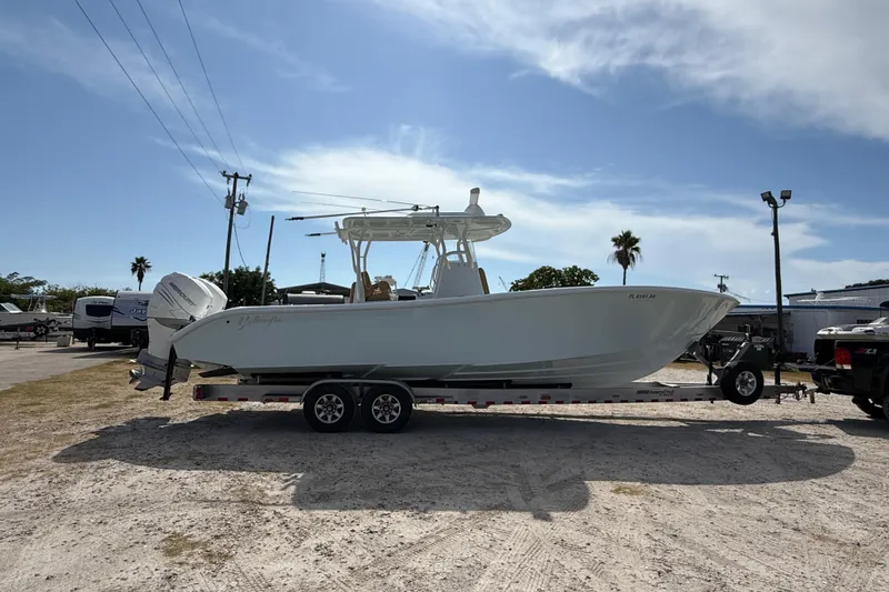  Yacht Photos Pics 2018 Yellowfin 32 Offshore boat on trailer under clear sky.