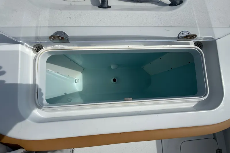  Yacht Photos Pics Open storage compartment on 2018 Yellowfin 32 Offshore boat, featuring a clean interior.