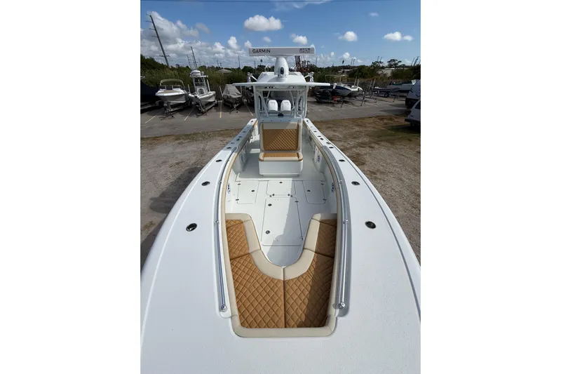  Yacht Photos Pics 2018 Yellowfin 32 Offshore boat with tan seating, docked under a blue sky.