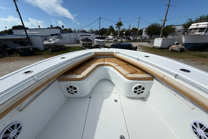  Yacht Photos Pics 2018 Yellowfin 32 Offshore boat with tan seating and white deck, parked outdoors.
