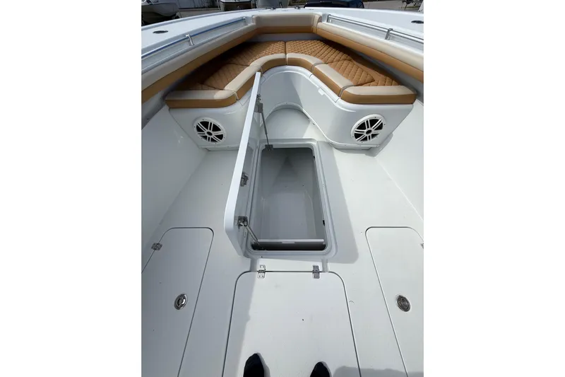  Yacht Photos Pics 2018 Yellowfin 32 Offshore boat interior with storage compartment and cushioned seating.