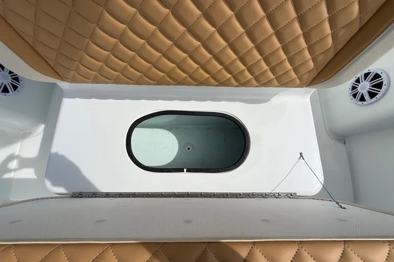  Yacht Photos Pics 2018 Yellowfin 32 Offshore boat interior with tan quilted seats and oval hatch.