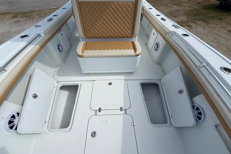  Yacht Photos Pics 2018 Yellowfin 32 Offshore boat interior with storage compartments and cushioned seating.