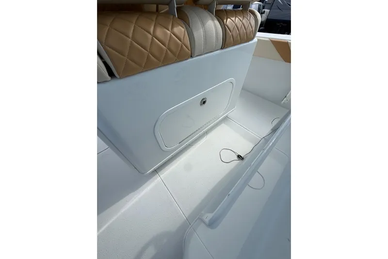  Yacht Photos Pics 2018 Yellowfin 32 Offshore boat interior with tan quilted seating and storage compartment.