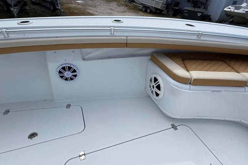  Yacht Photos Pics 2018 Yellowfin 32 Offshore boat interior with cushioned seating and built-in speakers.