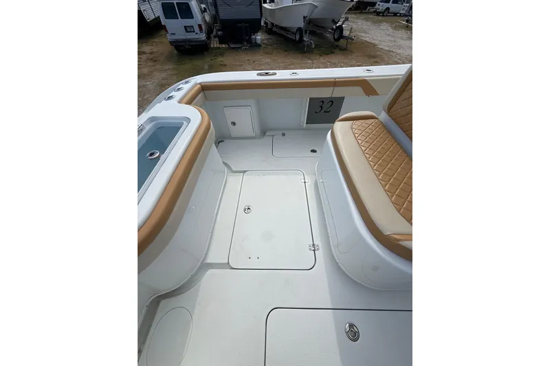  Yacht Photos Pics 2018 Yellowfin 32 Offshore boat interior with tan seating and storage compartments.