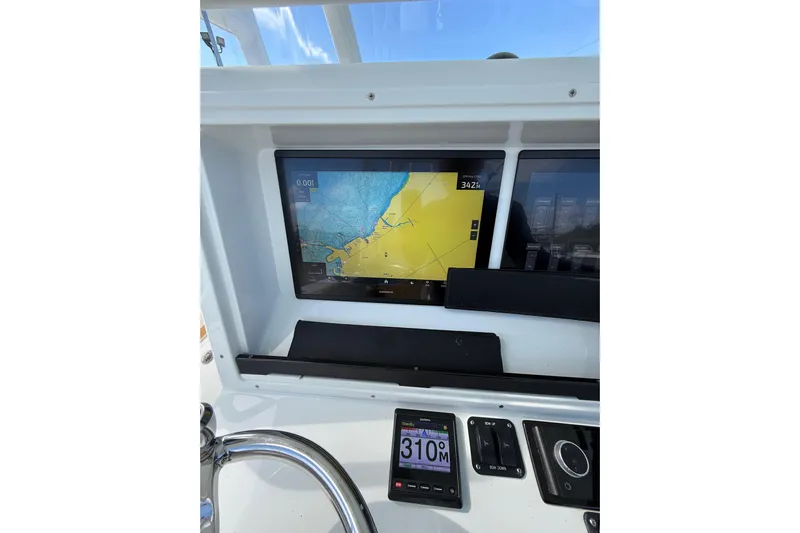  Yacht Photos Pics 2018 Yellowfin 32 Offshore boat dashboard with navigation display and controls.
