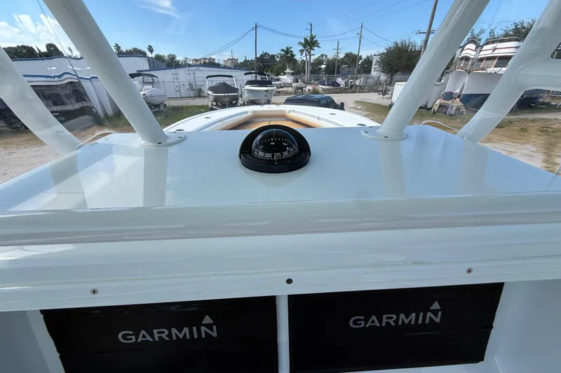  Yacht Photos Pics 2018 Yellowfin 32 Offshore boat dashboard with compass and Garmin displays.