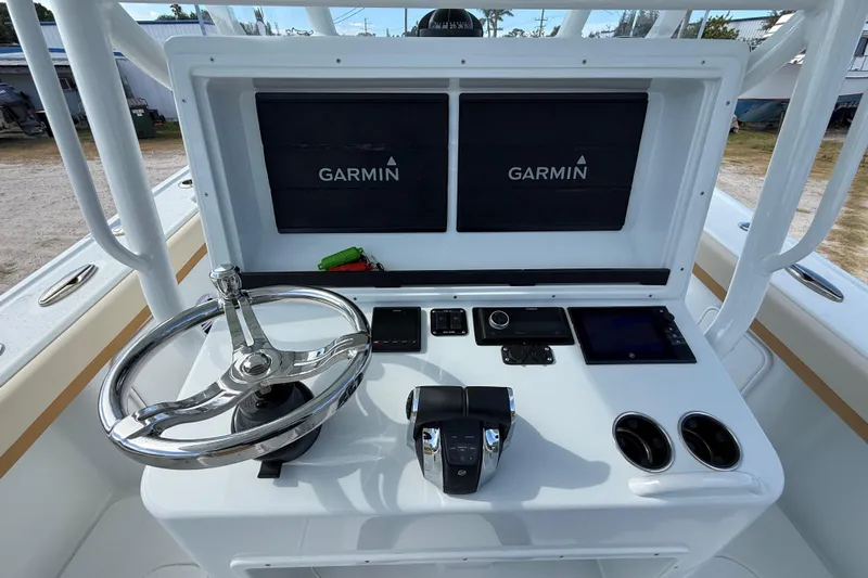 Yacht Photos Pics 2018 Yellowfin 32 Offshore boat console with Garmin displays and steering wheel.