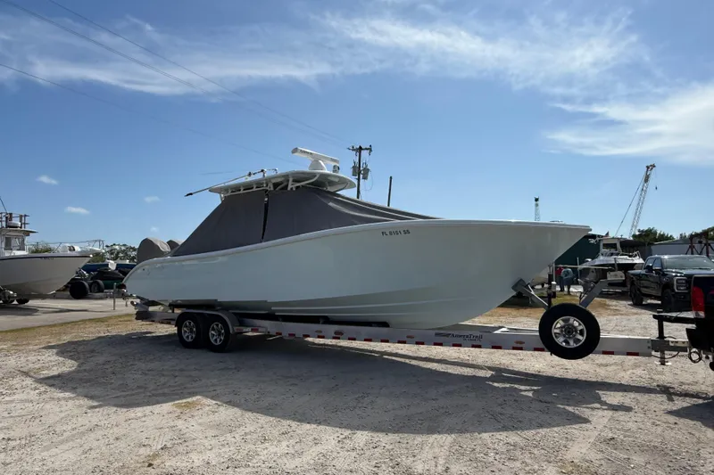  Yacht Photos Pics 2018 Yellowfin 32 Offshore boat on trailer under clear blue sky.