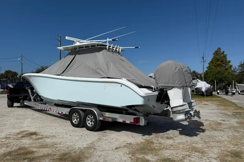  Yacht Photos Pics 2018 Yellowfin 32 Offshore boat on trailer, covered, parked outdoors.