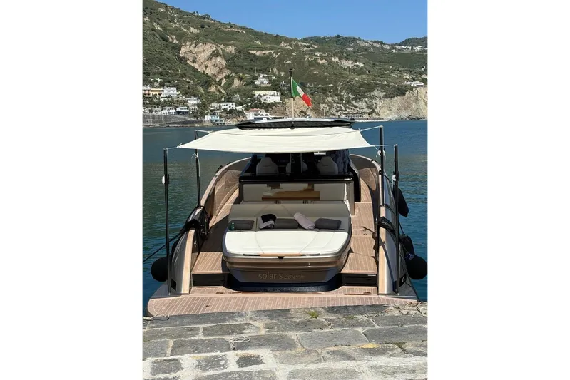  Yacht Photos Pics 2024 Solaris Power 44 yacht docked with scenic coastal backdrop.
