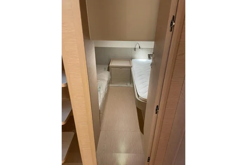  Yacht Photos Pics 2024 Solaris Power 44 yacht interior cabin with modern wooden design and cozy bed.