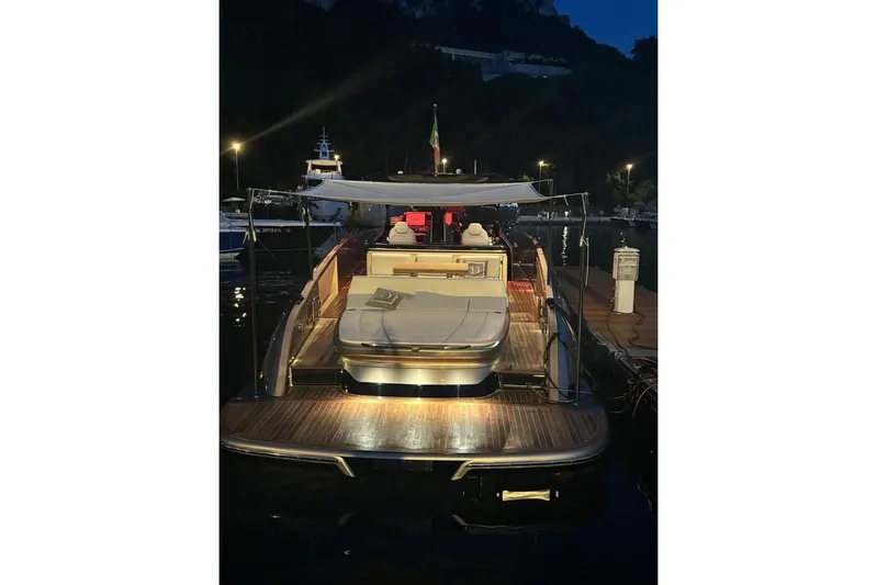  Yacht Photos Pics 2024 Solaris Power 44 yacht docked at night, featuring elegant deck lighting.