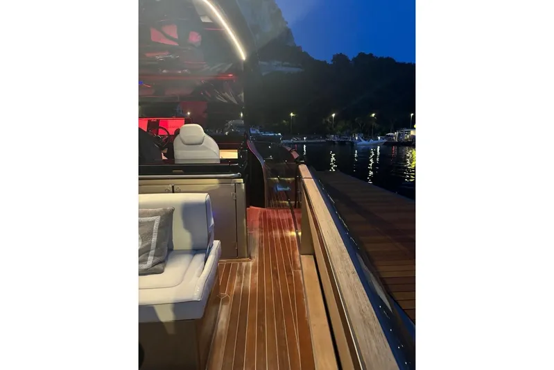  Yacht Photos Pics 2024 Solaris Power 44 yacht interior at night, docked by illuminated waterfront.