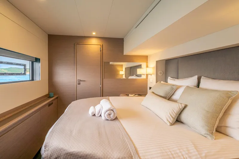 Semper Fidelis Yacht Photos Pics Luxurious bedroom interior of 2022 Fountaine Pajot Alegria 67 yacht with elegant decor.