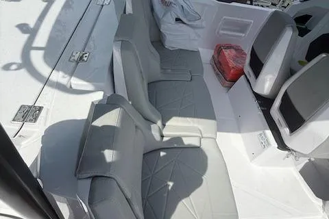  Yacht Photos Pics 2025 Axopar 29 Sun Top boat interior with gray seating and storage compartments.