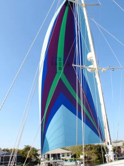 Vitesse Yacht Photos Pics Colorful sail of a 1989 Lagoon 55 yacht against a clear sky.