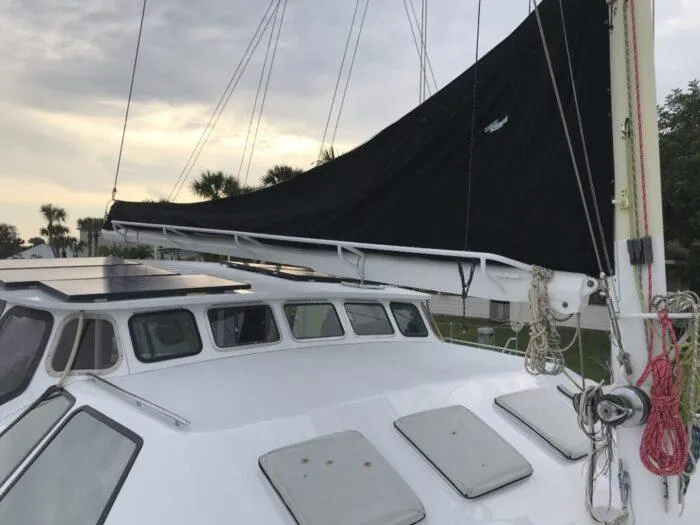 Vitesse Yacht Photos Pics Lagoon 55 sailboat from 1989 with covered mainsail and deck view.